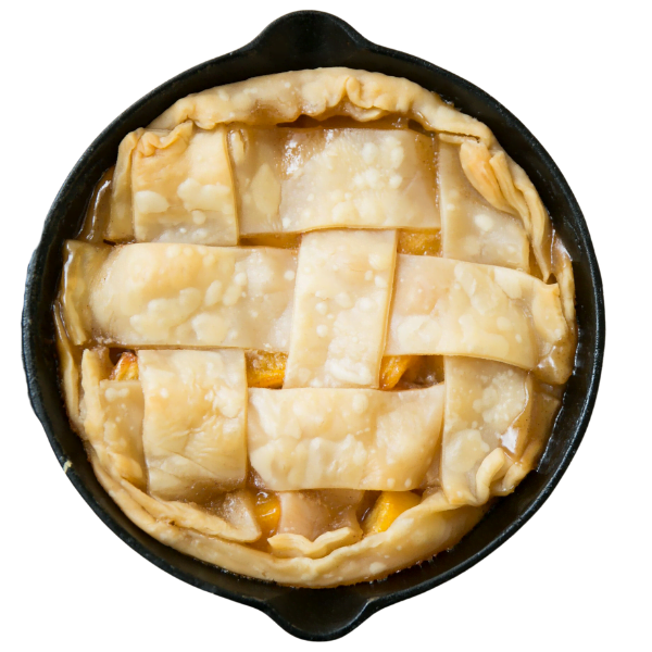 Freshly baked peach pie in a cast iron skillet with a lattice crust, straight from home.